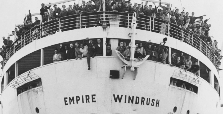 Front shot of the Empire Windrush with people waving