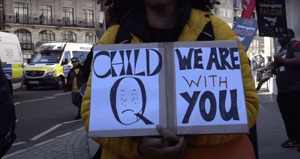protestor holding a banner supporting Child Q